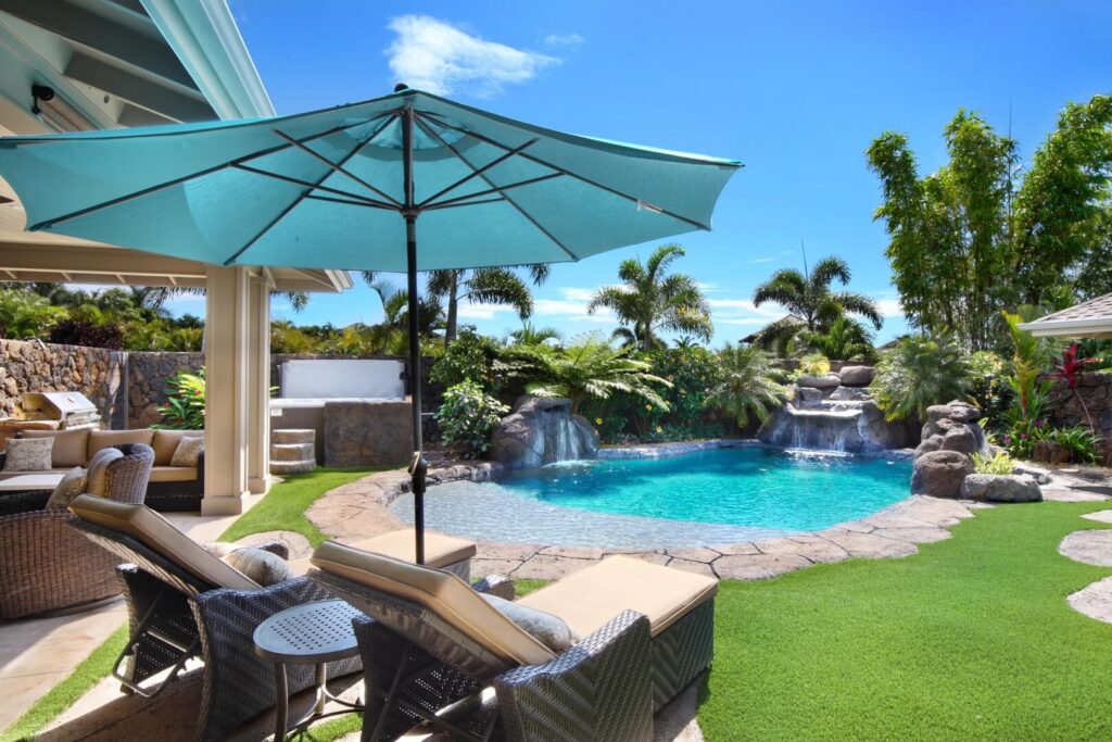 The backyard pool area of a luxury Kauai rental to relax in.